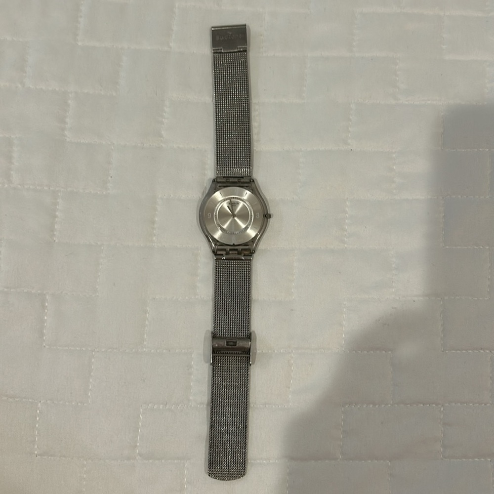 Stainless steel Swatch watch with extra battery.
